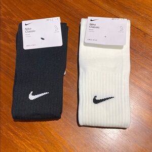 Two pairs of Nike soccer socks - black and white